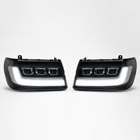 LandCruiser 100/105 Series bi-LED headlights — left and right pair on white background