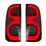 Hilux N70 angular multi-bar LED tail light close-up, lit