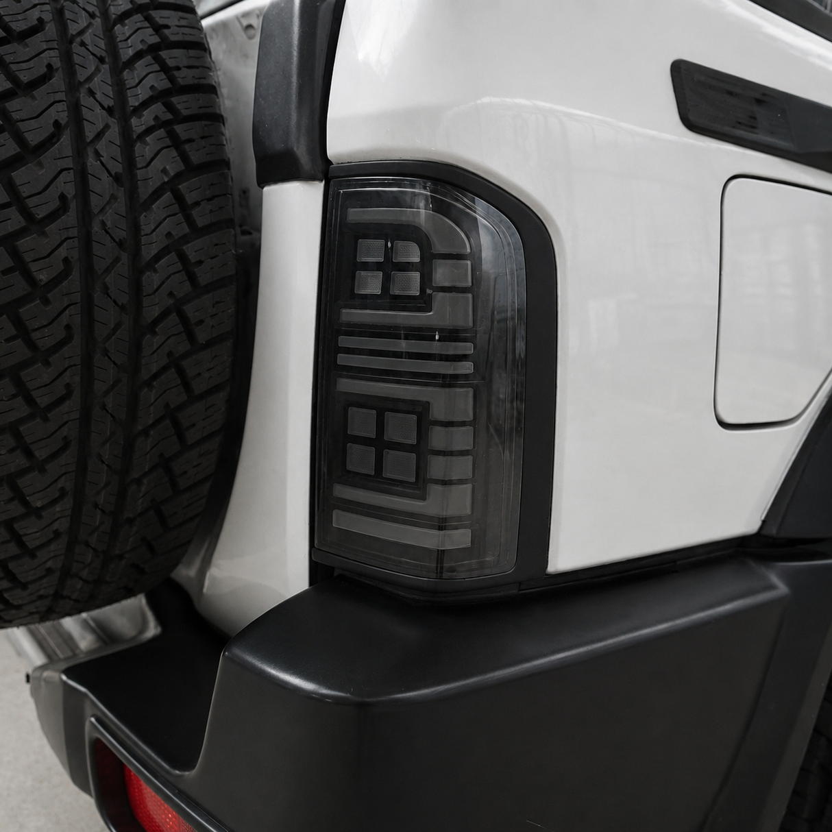 Close-up of Nissan GU Patrol Series 1-3 smoked LED tail light with brake light glowing red