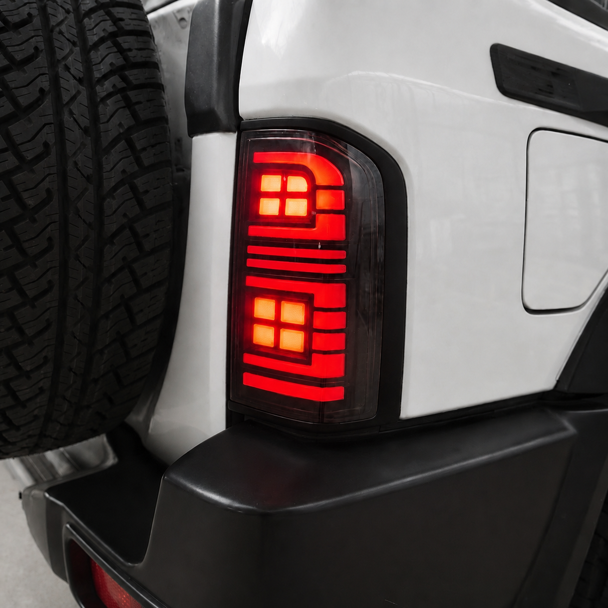 Close-up of Nissan GU Patrol Series 1-3 smoked LED tail light with reverse light glowing white