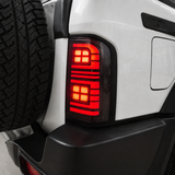 Close-up of Nissan GU Patrol Series 1-3 smoked LED tail light with reverse light glowing white