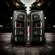 Smoked tail lights installed on Mitsubishi Triton MR, factory-style housing